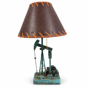 Rustic Western table lamp featuring an oil pumpjack base with turquoise patina finish and brown leather-look shade