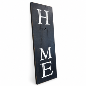 Tall rustic black wooden wall sign with white HOME lettering and decorative metal hook