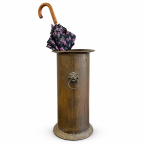 Tall antique-style brass umbrella stand with decorative lion head ring handle and umbrella.