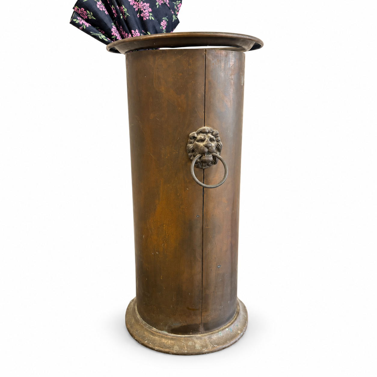 Tall antique-style brass umbrella stand with decorative lion head ring handle and umbrella.