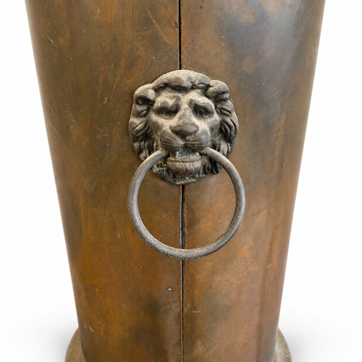 Tall antique-style brass umbrella stand with decorative lion head ring handle and umbrella.