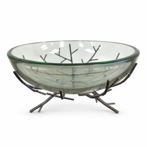 Clear glass decorative bowl resting on a dark metal branch-inspired stand.