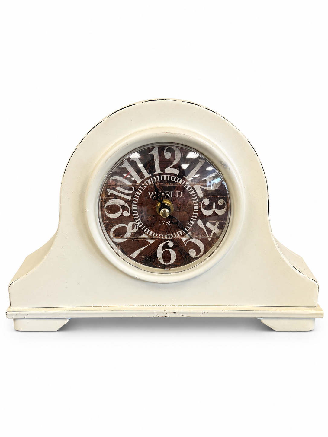 Vintage-style cream mantel clock with a distressed finish and decorative Roman numeral-inspired clock face.