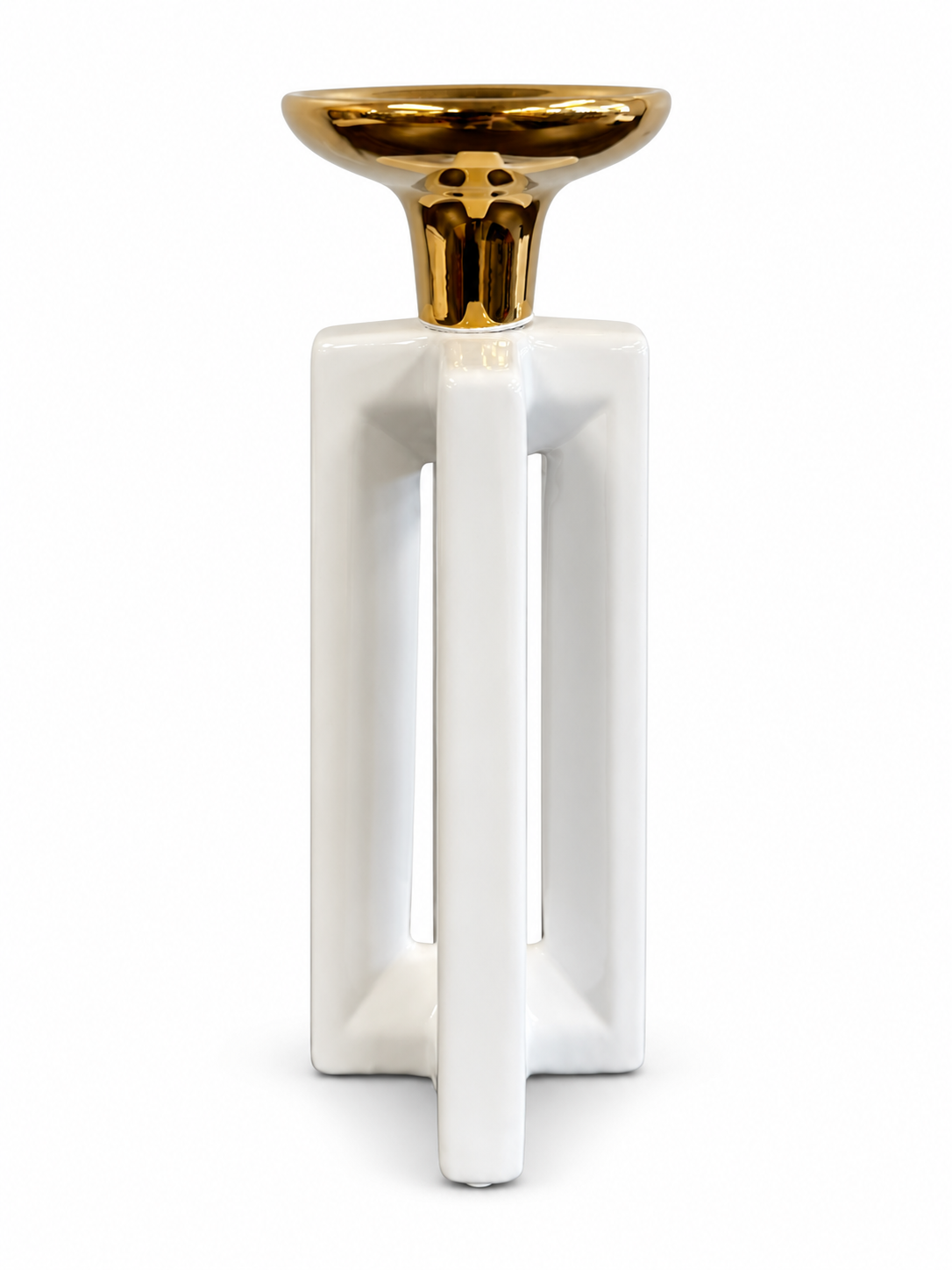 Modern white ceramic candle holder with an open geometric base and polished gold top.