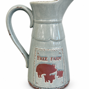 Light blue-gray ceramic farmhouse pitcher with crackle glaze, distressed accents, and raised pig design.