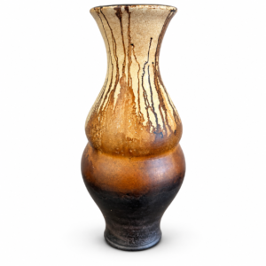 Tall amber and black decorative vase with a curved silhouette and artistic dark drip detailing.