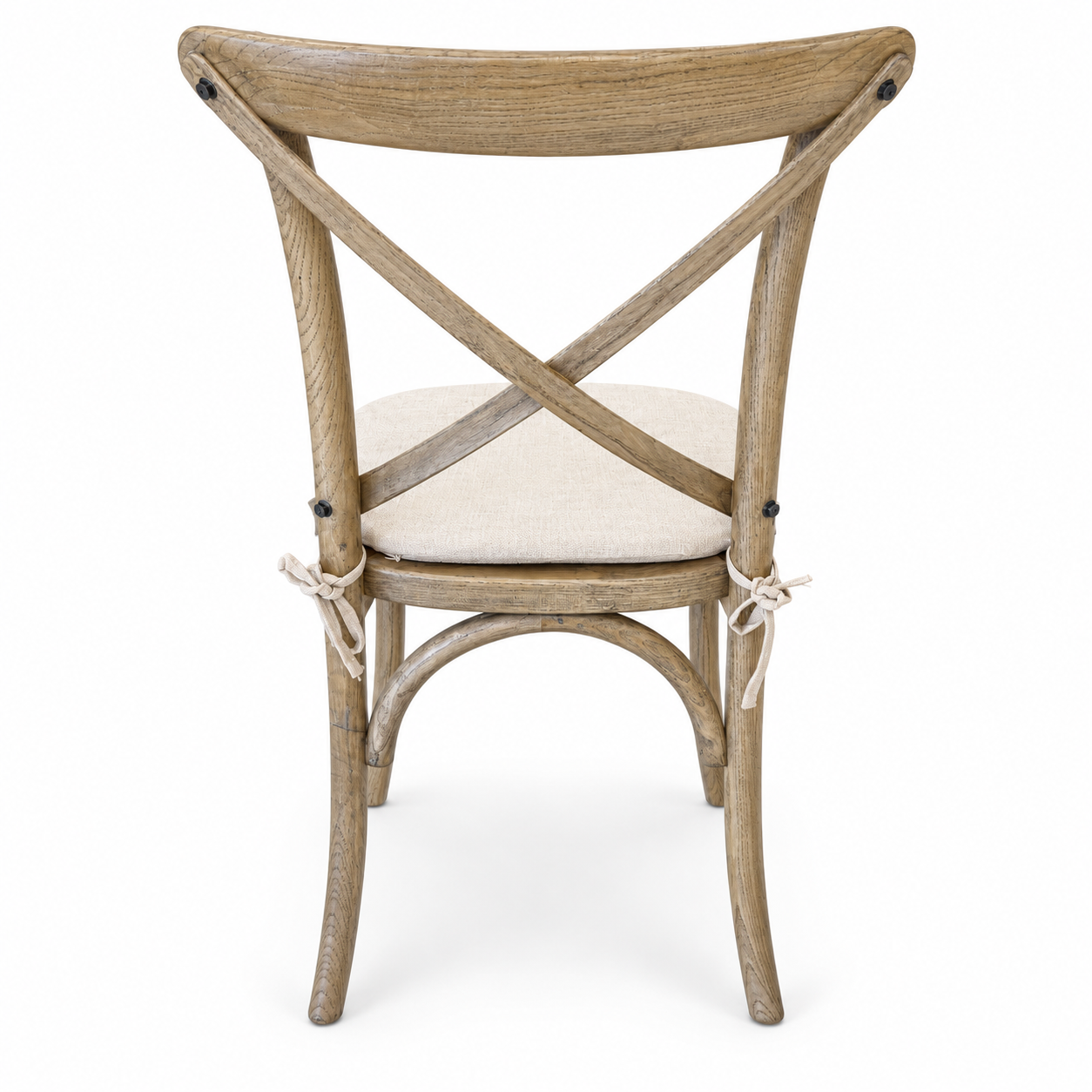 Natural wood cross-back dining chair with curved legs and light neutral upholstered seat