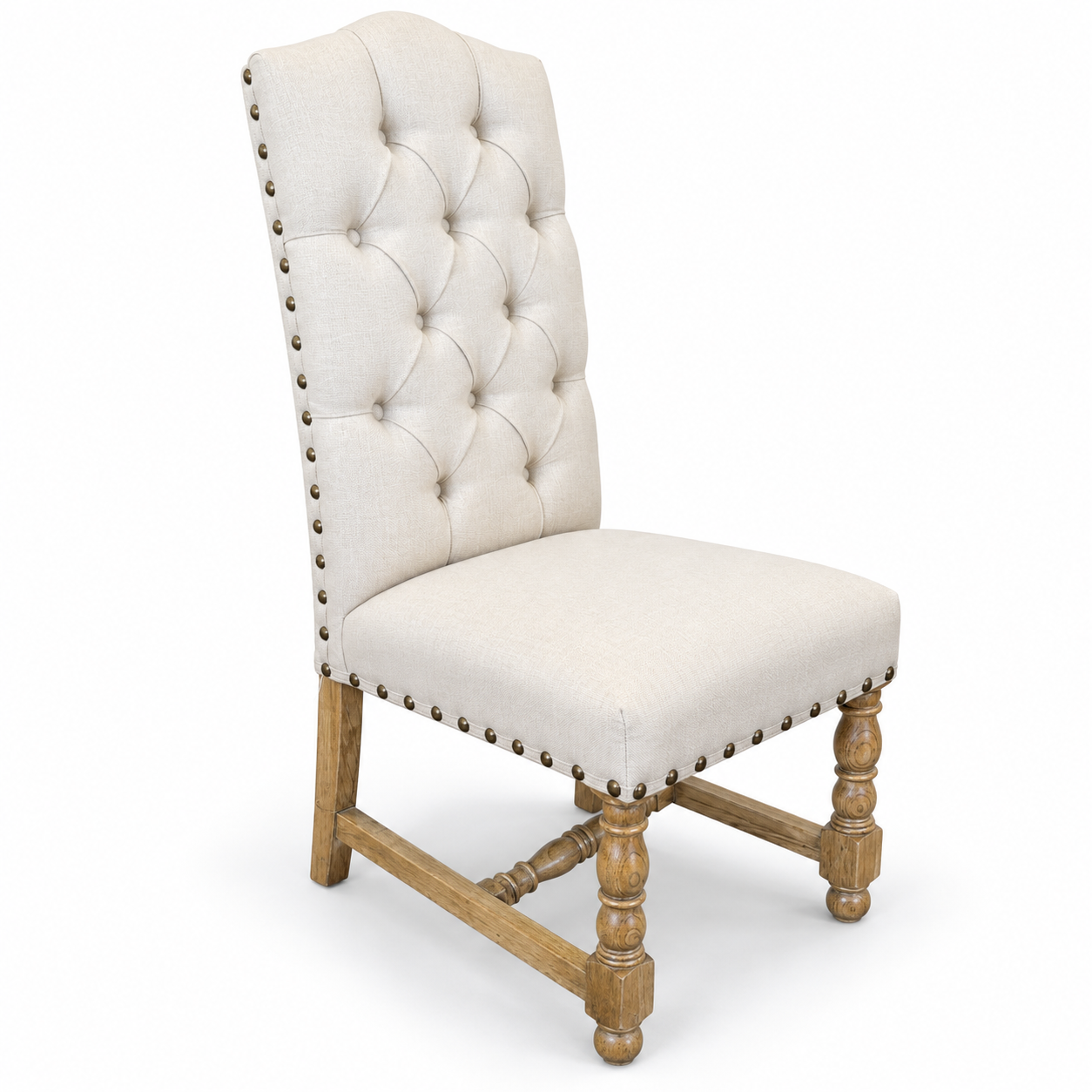 Cream upholstered high-back dining chair with button tufting, brass nailhead trim, and turned wood legs