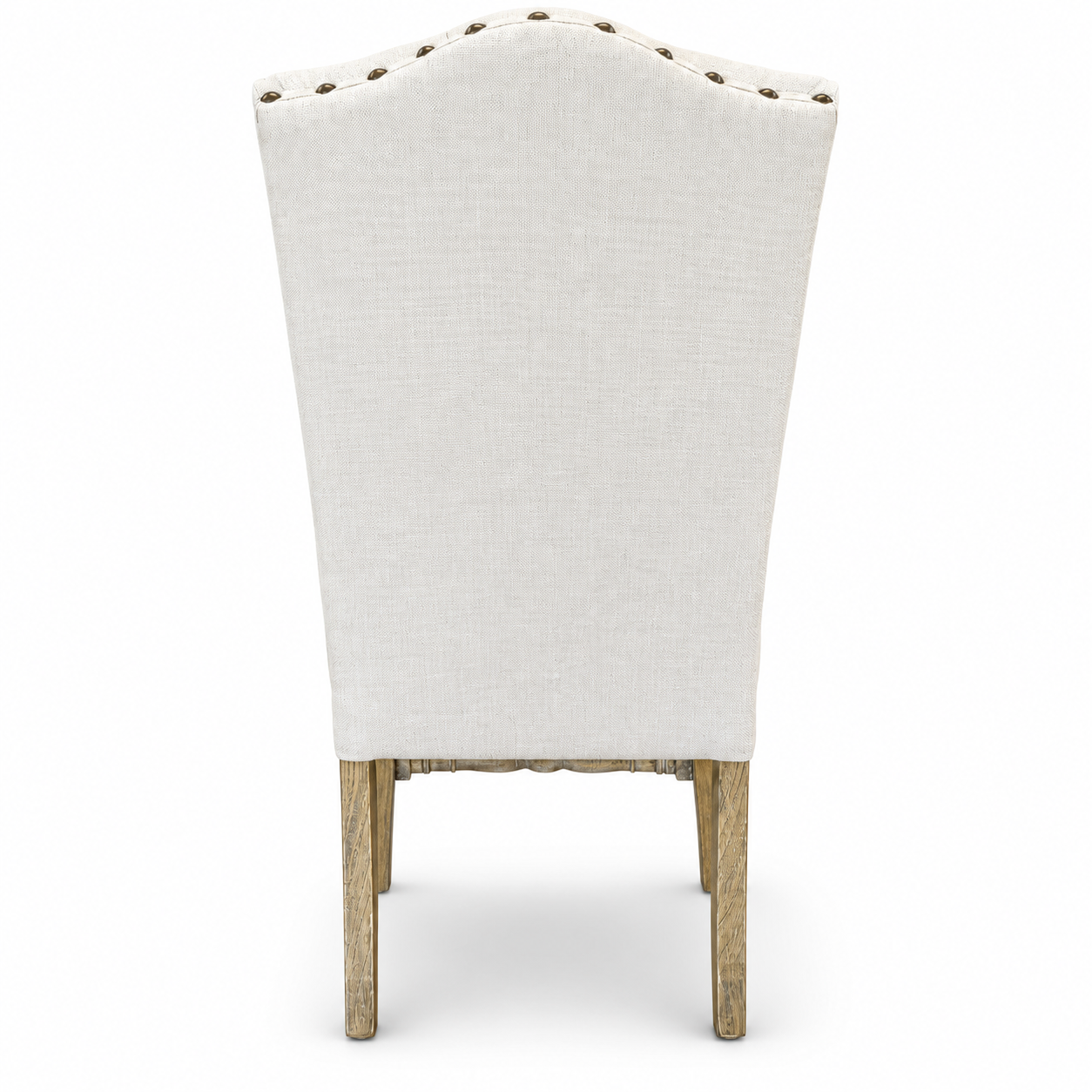 Cream upholstered high-back dining chair with button tufting, brass nailhead trim, and turned wood legs