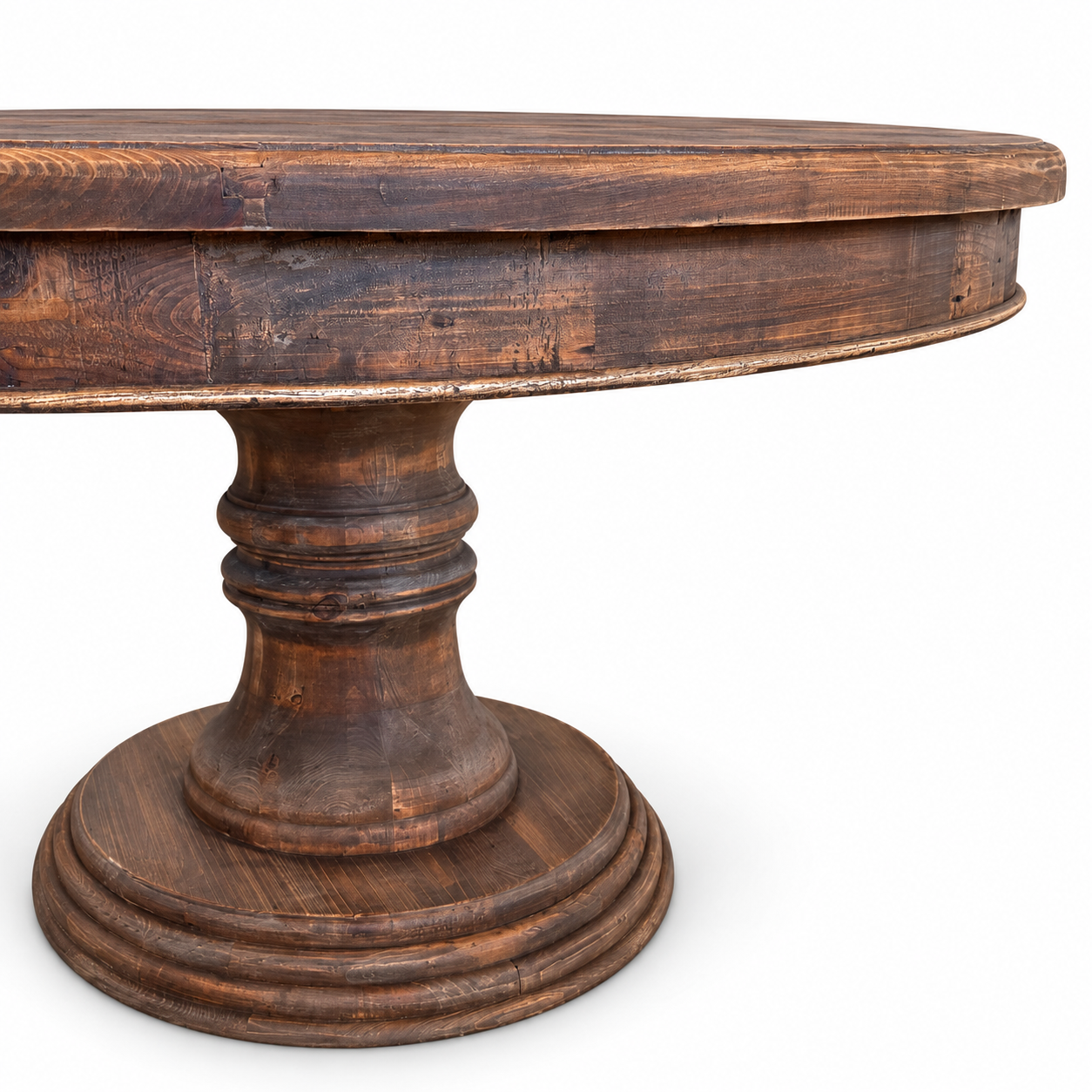 Round rustic wood pedestal dining table with natural wood grain and a substantial carved base.