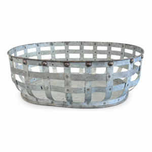 Rustic galvanized metal basket with woven open-grid design, riveted details, and distressed farmhouse finish.