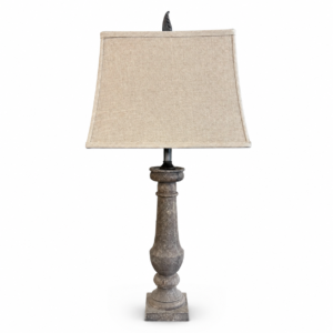 Rustic gray table lamp with distressed turned wood base and beige linen shade.