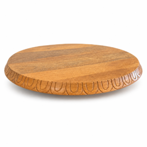 Round wooden Lazy Susan with natural wood grain and decorative carved edge.