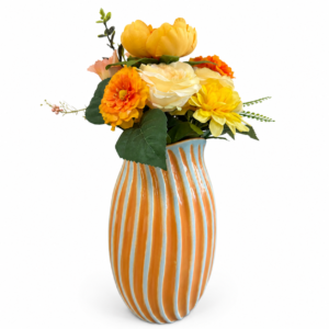 Orange and light blue striped ceramic vase with colorful yellow, orange, cream, and peach floral arrangement.