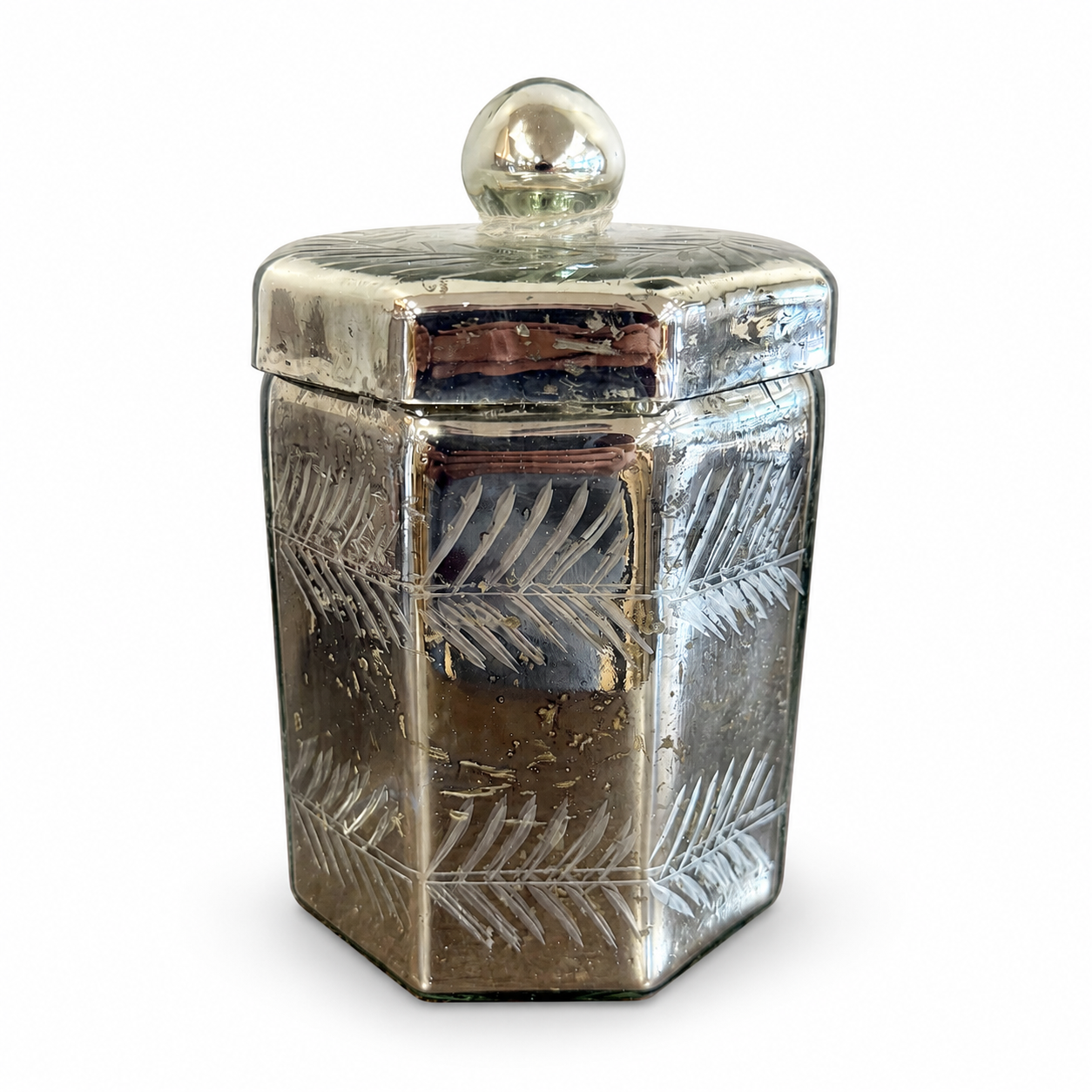 Antique-style mercury glass lidded jar with etched leaf pattern, reflective silver finish, and round glass finial.