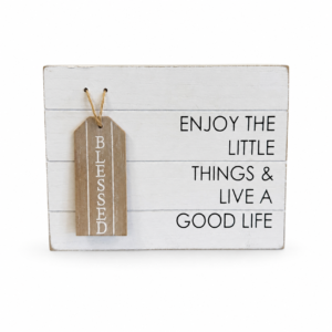 White rustic wood sign reading “Enjoy the Little Things & Live a Good Life” with a hanging wooden Blessed tag.