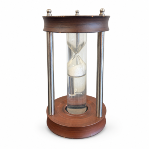 Decorative hourglass with wood frame, metal supports, clear glass, and white sand.