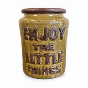 Mustard yellow ceramic decorative vase with brown lettering that reads Enjoy the Little Things.