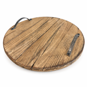 Round wood serving tray with natural distressed finish and two dark metal handles.